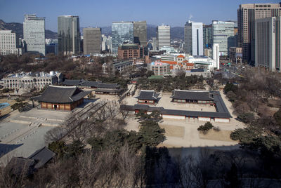 Buildings in city on sunny day