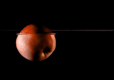 Close-up of apple against black background