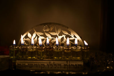 Close-up of illuminated candles in temple