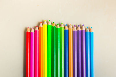 Close-up of colored pencils against white background