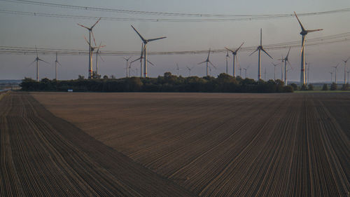 Electricity pylon on field against sky