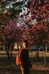 Portrait of man standing against trees during autumn