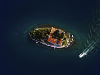 High angle view of sailboat in sea against buildings