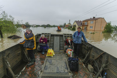 People standing on boat against sky