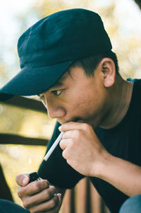 Close-up of man igniting cigarette