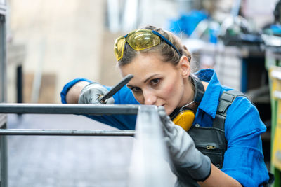 Close-up of woman working in factory