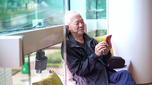 Woman using mobile phone in office