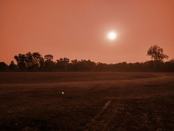 Scenic view of field against sky during sunset