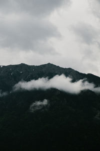 Scenic view of mountains against cloudy sky