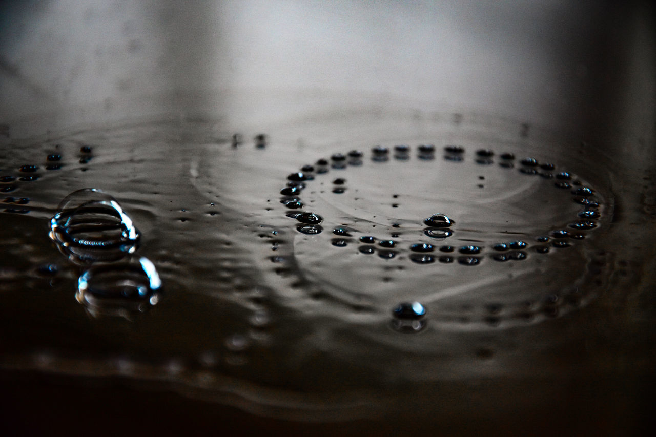 selective focus, indoors, no people, water, close-up, household equipment, bubble, drop, reflection, sink, high angle view, metal, nature, purity, backgrounds, shape, motion, wet, shiny, glass, clean