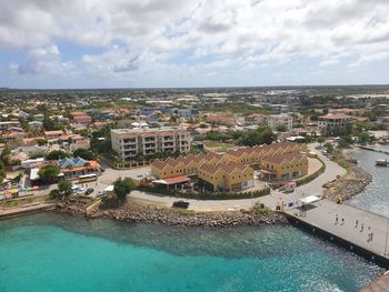 High angle view of townscape by sea against sky