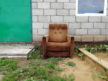 Empty chair against wall