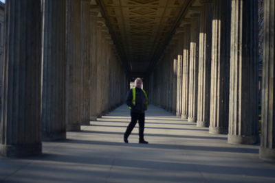 Full length of man walking in corridor of building