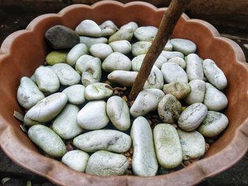 High angle view of pebbles in container