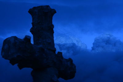 Low angle view of statue against blue sky