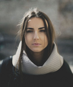 Portrait of beautiful young woman wearing warm clothing outdoors