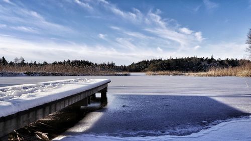 Scenic view of frozen lake against sky during winter