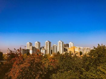 Modern buildings against clear blue sky