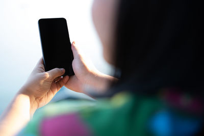Midsection of man using mobile phone