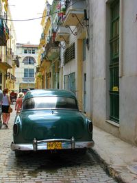 Cars on street amidst buildings in city