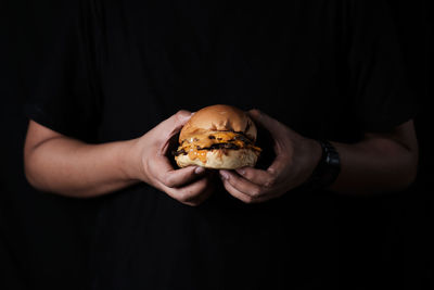 Midsection of man holding food