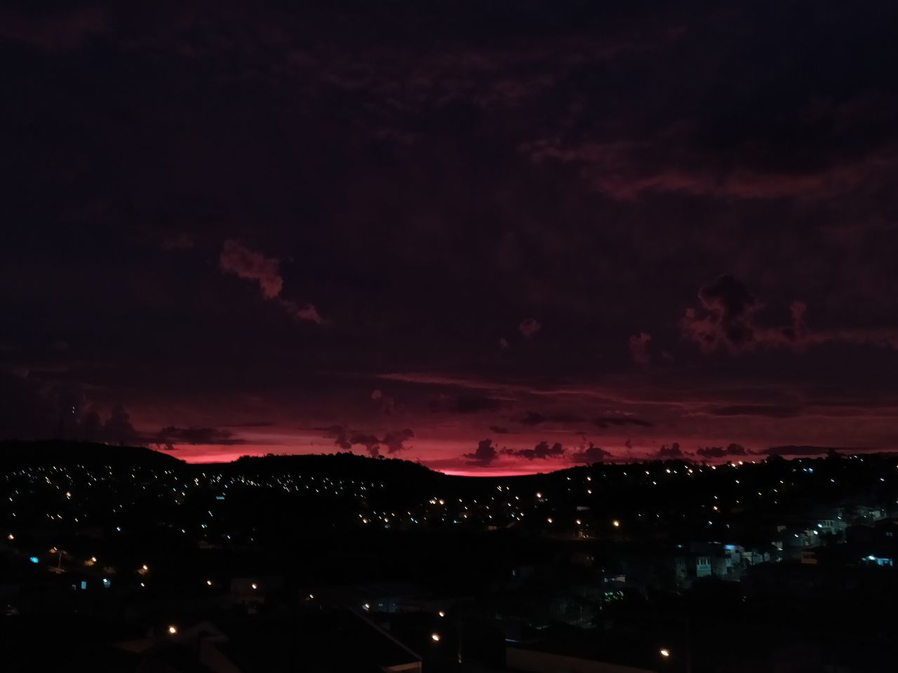 ILLUMINATED CITYSCAPE AGAINST SKY AT NIGHT