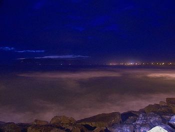 Scenic view of illuminated landscape against sky at night