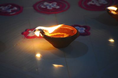 Close-up of lit candles on table