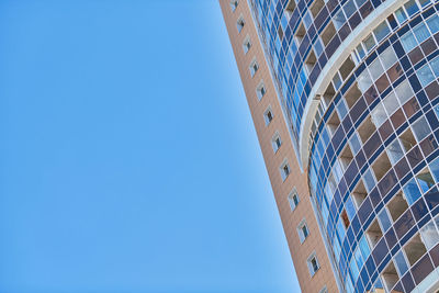 Low angle view of building against clear blue sky