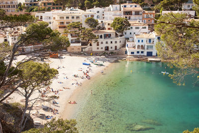 High angle view of townscape by sea with people enjoying summer sun and mediterranean sea