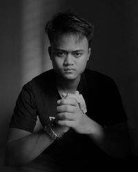 Portrait of man sitting in darkroom