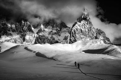 Scenic view of snow covered mountains against sky