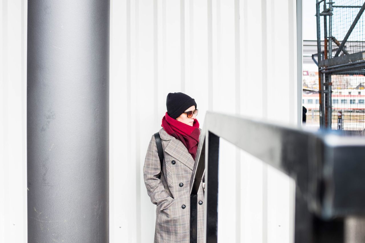one person, standing, clothing, young adult, lifestyles, real people, winter, warm clothing, day, young women, leisure activity, architecture, scarf, adult, built structure, waist up, three quarter length, front view, outdoors, beautiful woman