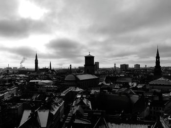 Cityscape against cloudy sky
