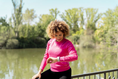 Athlete woman using smartwatch to monitor your heart rate