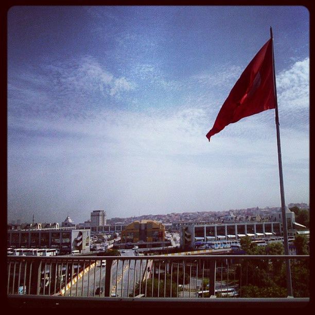 flag, patriotism, identity, national flag, american flag, architecture, built structure, building exterior, sky, transfer print, culture, city, wind, auto post production filter, striped, cloud, low angle view, day, red, outdoors