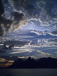 Scenic view of mountains against cloudy sky