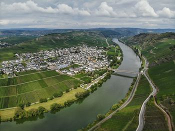 High angle view of river amidst cityscape against sky