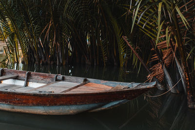 Abandoned boat moored in water