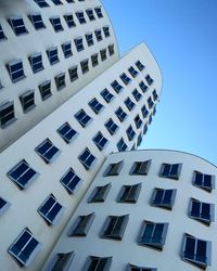 Low angle view of apartment building against clear sky