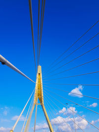 Low angle view of bridge against blue sky