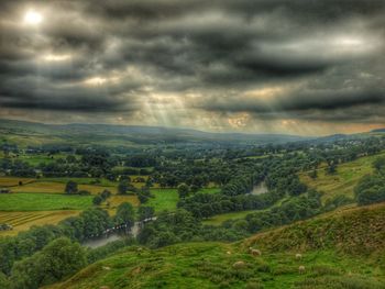 Scenic view of agricultural field against storm clouds