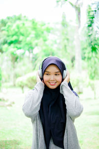 Portrait of young woman standing outdoors