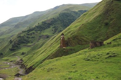 Scenic view of green mountains against sky