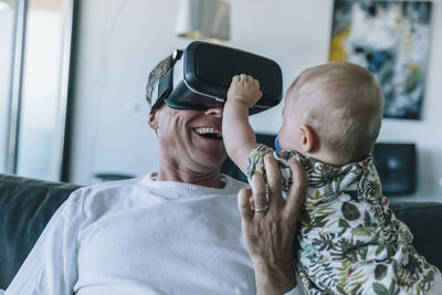 Rear view of mother and son at home