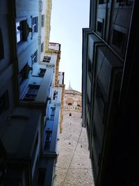 Low angle view of buildings in town against sky