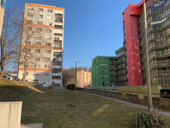 Buildings in city against clear sky