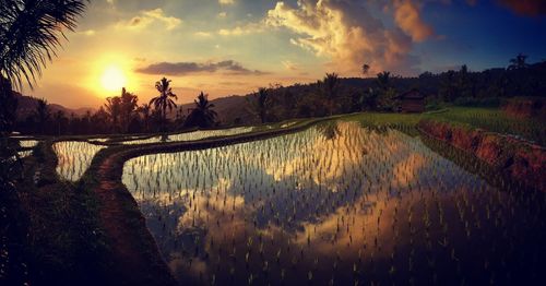 Scenic view of lake against sky during sunset