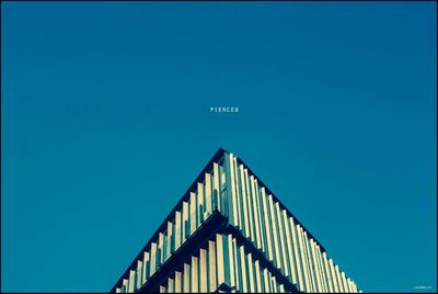 Low angle view of building against clear blue sky