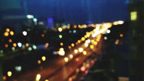 Defocused image of illuminated city at night